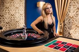 Dealer Live Baccarat mentosbola dengan kartu di meja kasino